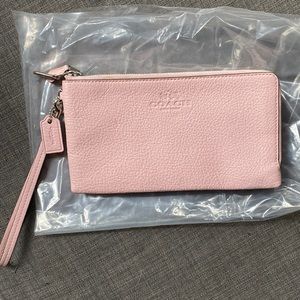 Pink coach clutch